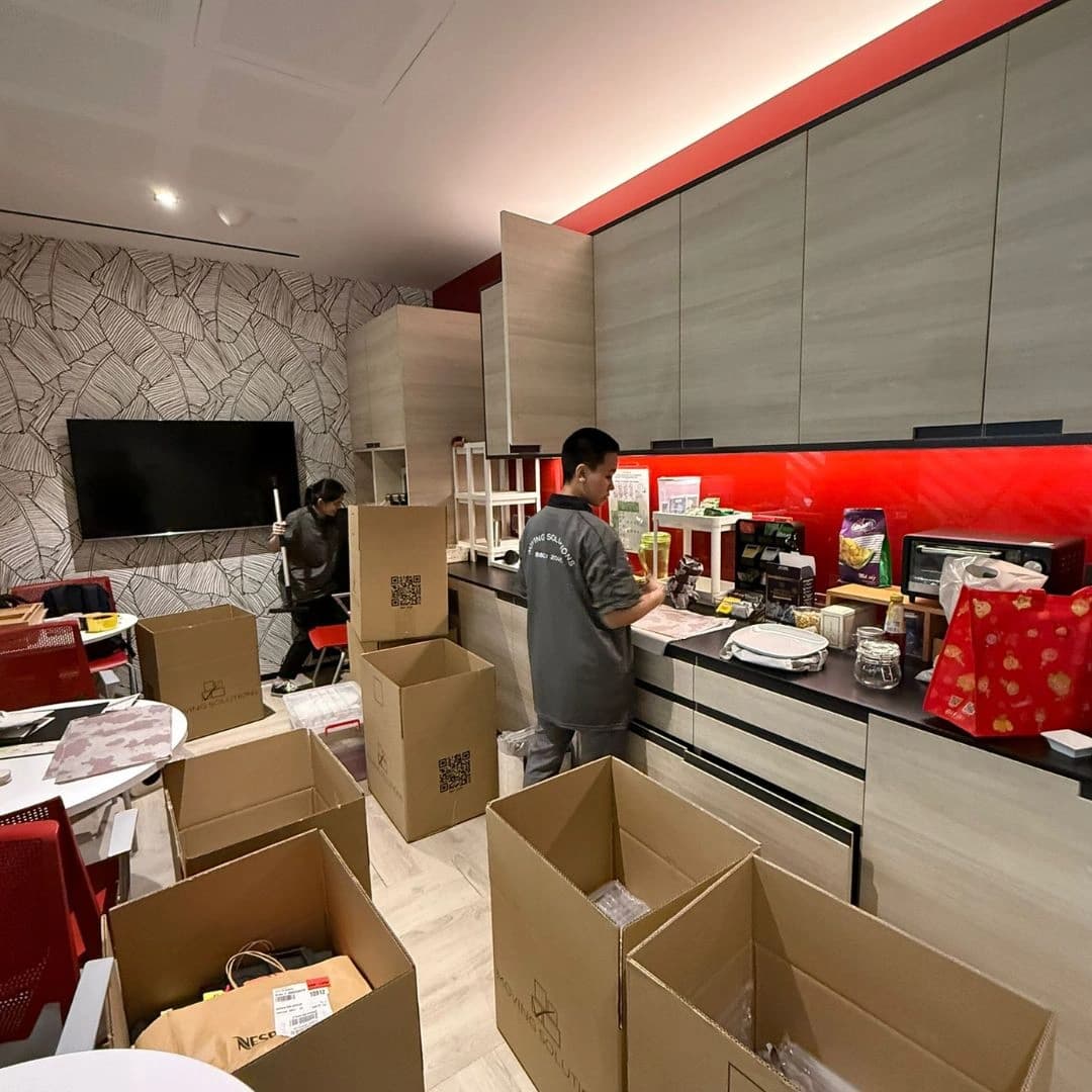 Crew packing household belongings into cartons
